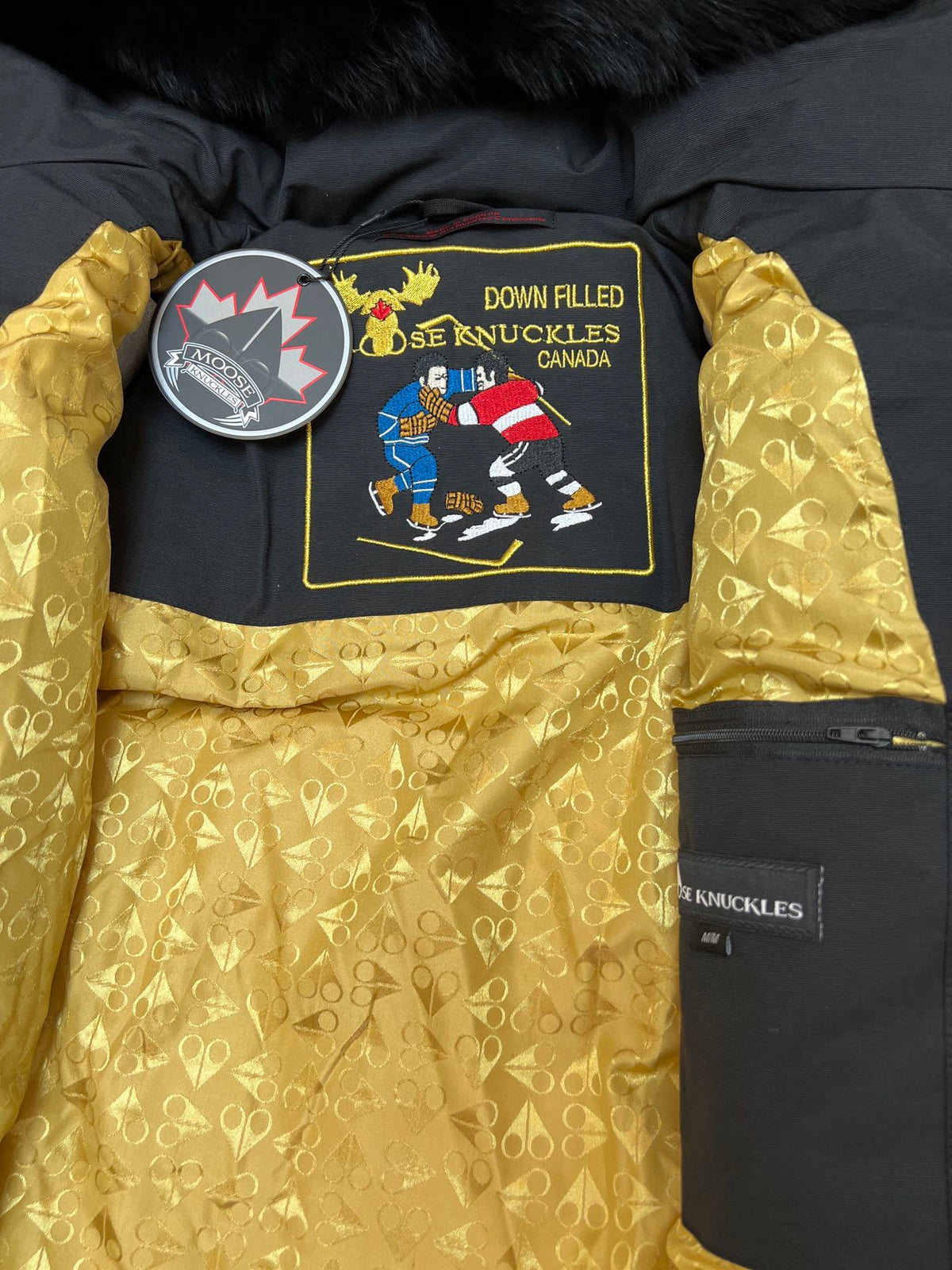 Moose Knuckles Black Hooded Puffer Jacket with Gold-Tone Details